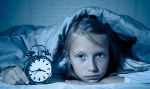 child having trouble staying asleep with clock